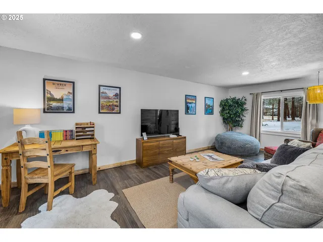 a bedroom with furniture and a flat screen tv