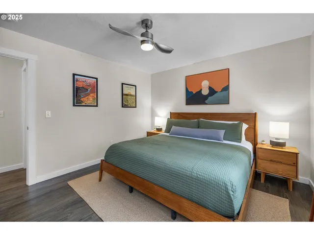 a bedroom with a bed and a painting on the wall