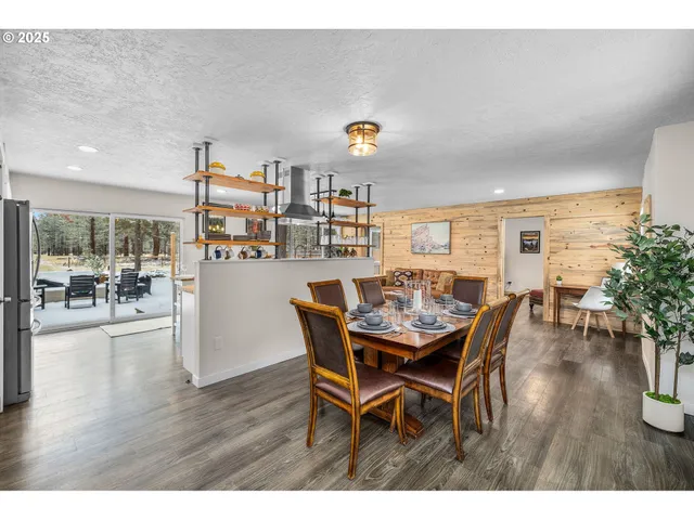 a dining room with furniture and wooden floor