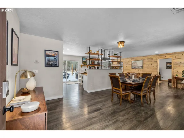 a dining room with furniture and wooden floor