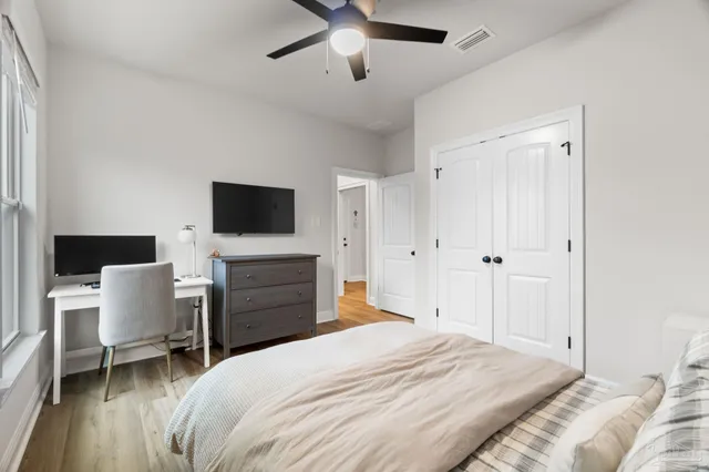 a bedroom with a bed and a window