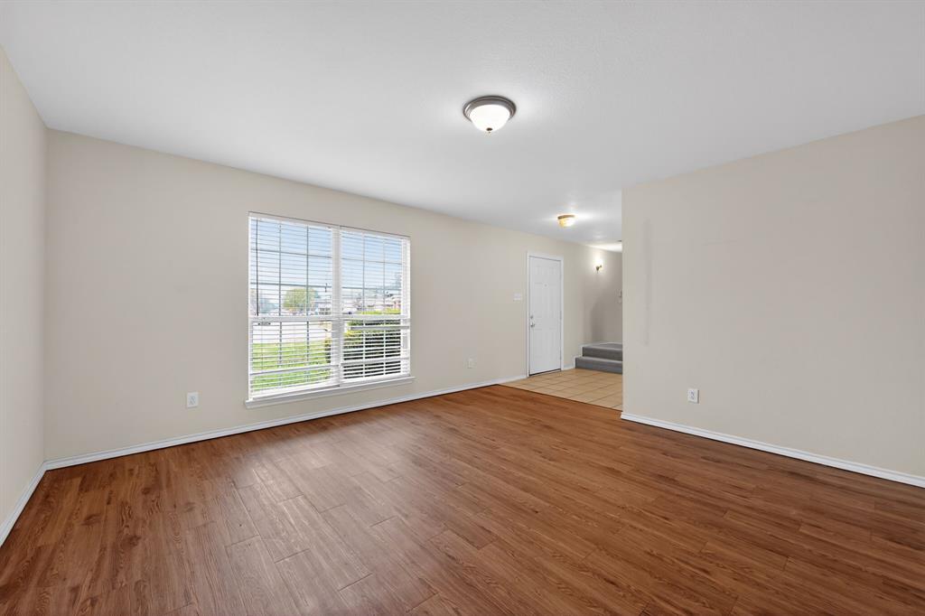 8618 Scooner Street Rowlett, TX 75089 - Photo 13 of 30 a view of an empty room with wooden floor and a window