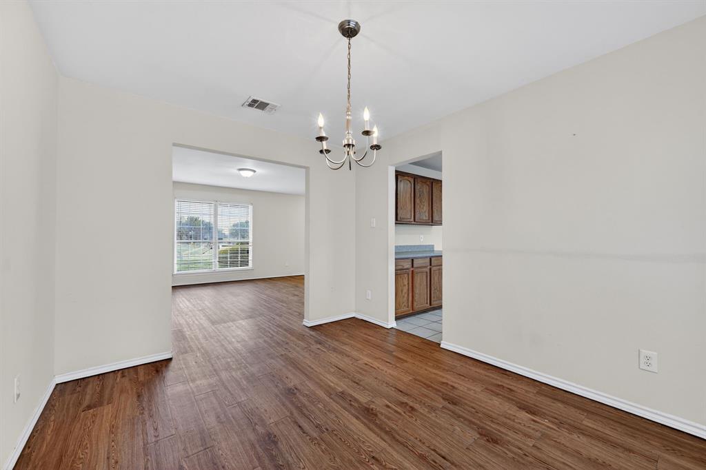 8618 Scooner Street Rowlett, TX 75089 - Photo 23 of 30 a view of a room with wooden floor chandelier and a window