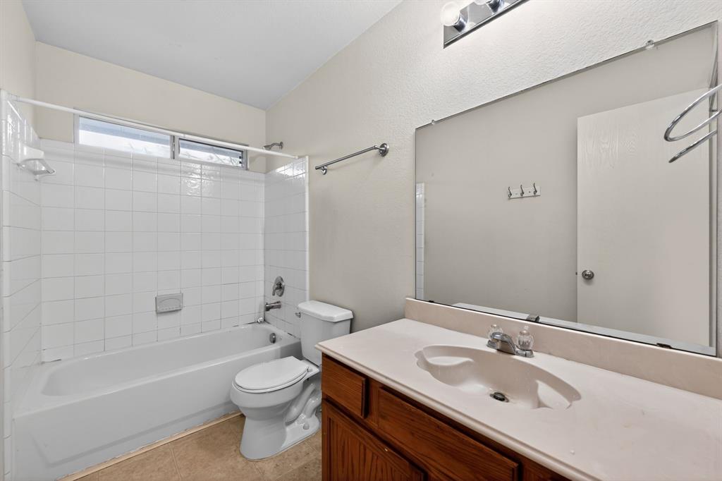 8618 Scooner Street Rowlett, TX 75089 - Photo 30 of 30 a bathroom with a sink toilet tub vanity and shower