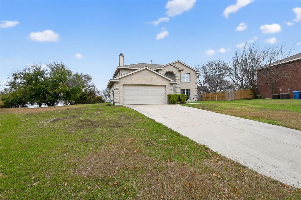 8618 Scooner Street Rowlett, TX 75089 - Photo 3 of 30 a front view of a house with a yard and garage