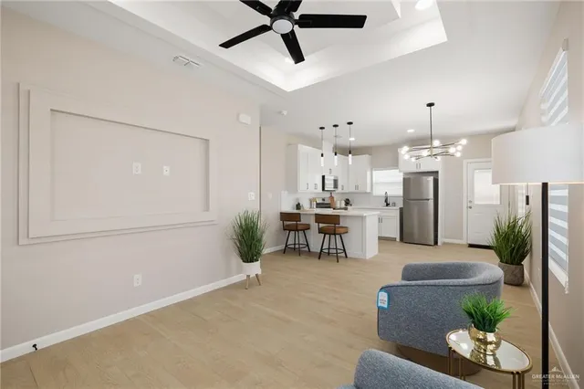 a living room with furniture and kitchen view
