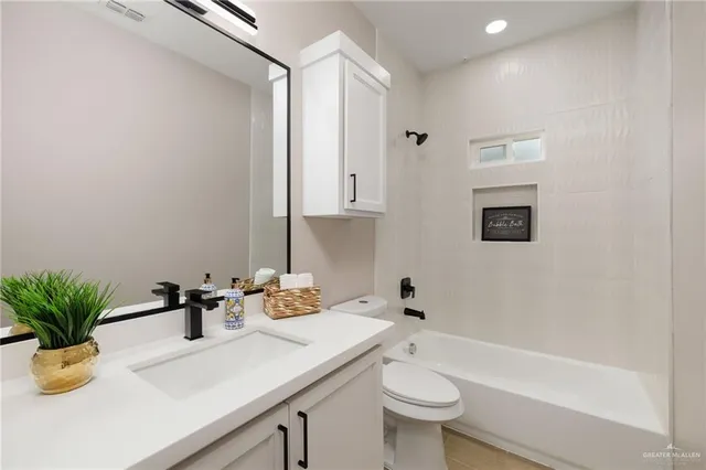 a bathroom with a sink a toilet and a bathtub