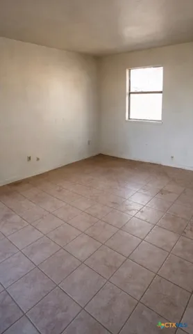 an empty room with a empty space and a window