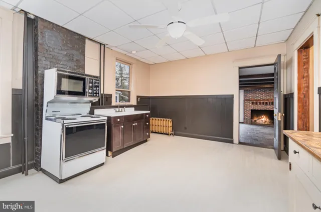 a kitchen with stainless steel appliances kitchen island granite countertop a refrigerator and a stove