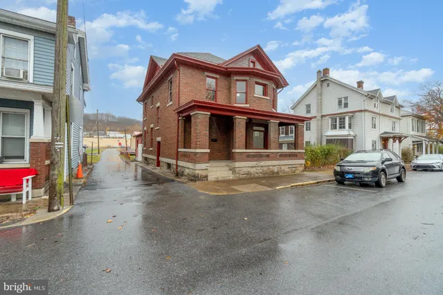 a view of a house with a cars park in front of house