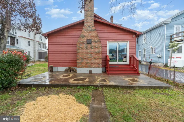 a view of a house with a yard and sitting area