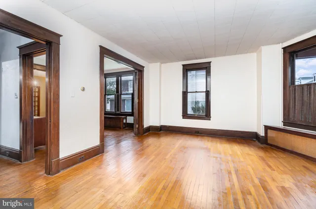 wooden floor in an empty room with a window