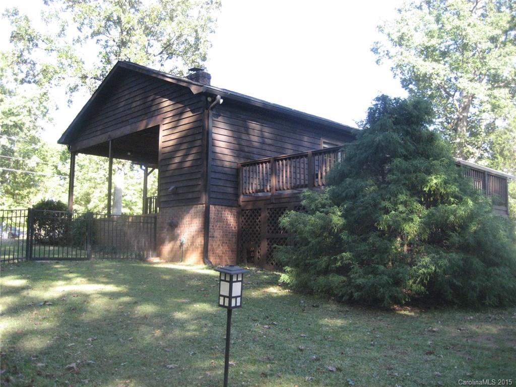 755 Shady Forest Road, Unit 2 Clover, SC 29710 - Photo 18 of 24 a backyard of a house with table and chairs under an umbrella