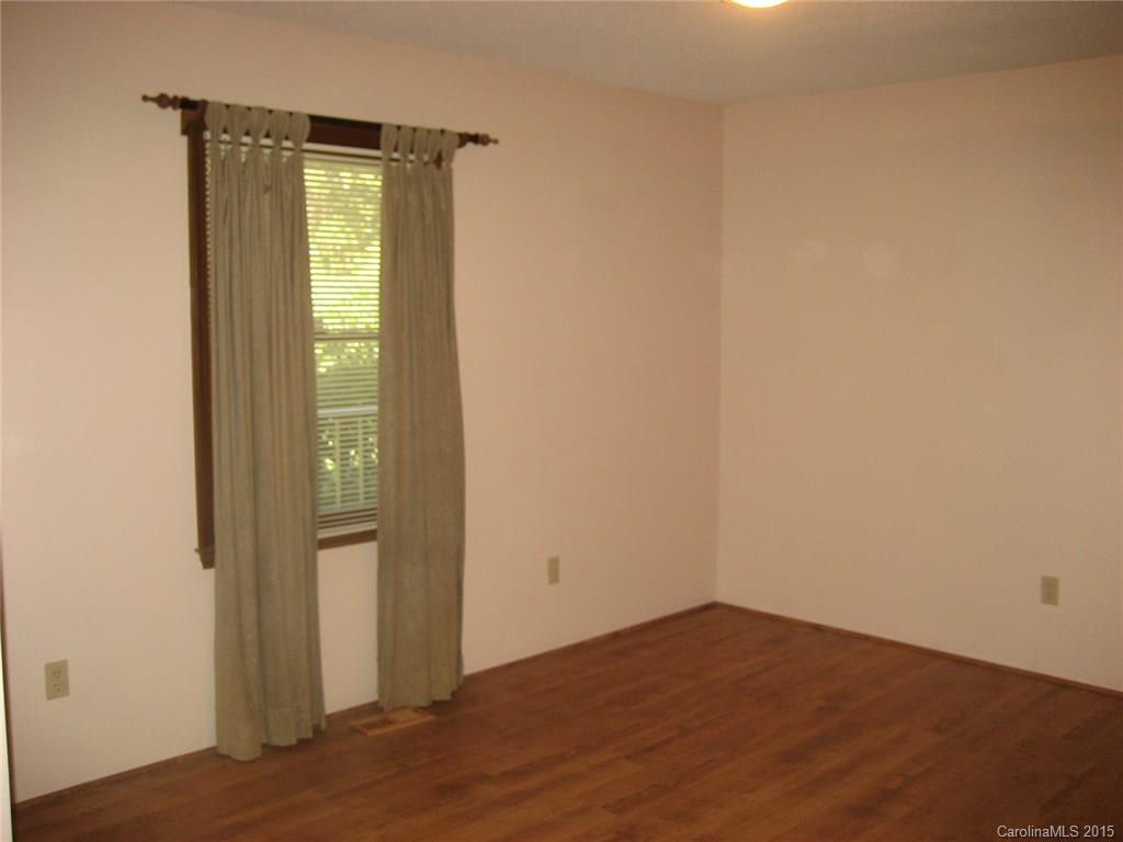 755 Shady Forest Road, Unit 2 Clover, SC 29710 - Photo 9 of 24 an empty room with wooden floor and windows