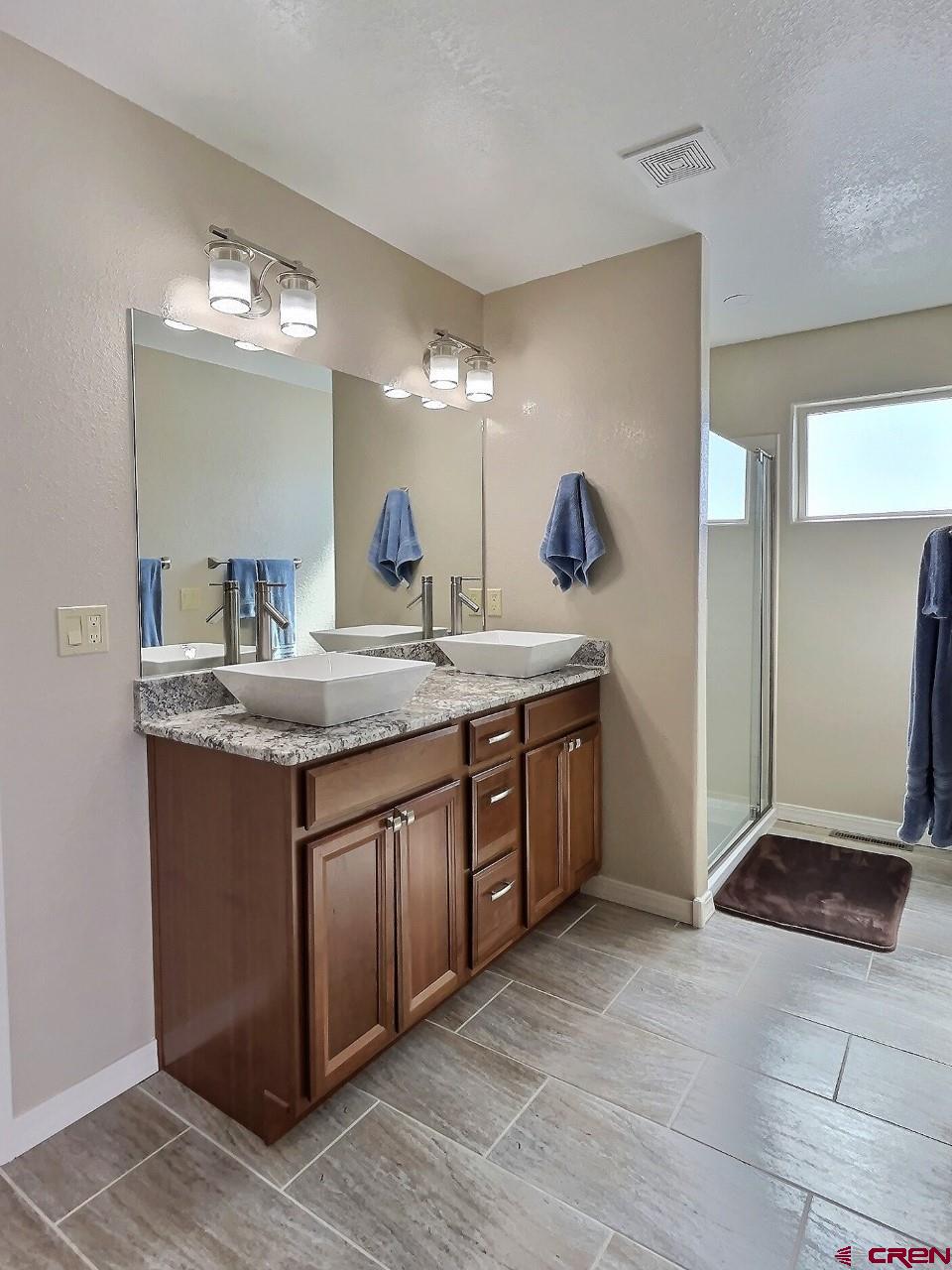 24835 Cactus Park Road Cedaredge, CO 81413 - Photo 11 of 35 a bathroom with a sink and a mirror