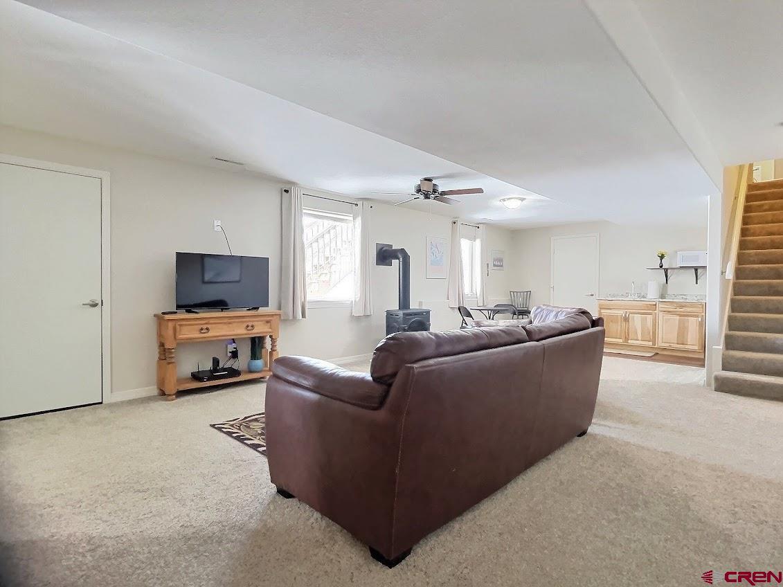 24835 Cactus Park Road Cedaredge, CO 81413 - Photo 14 of 35 a living room with furniture and a flat screen tv