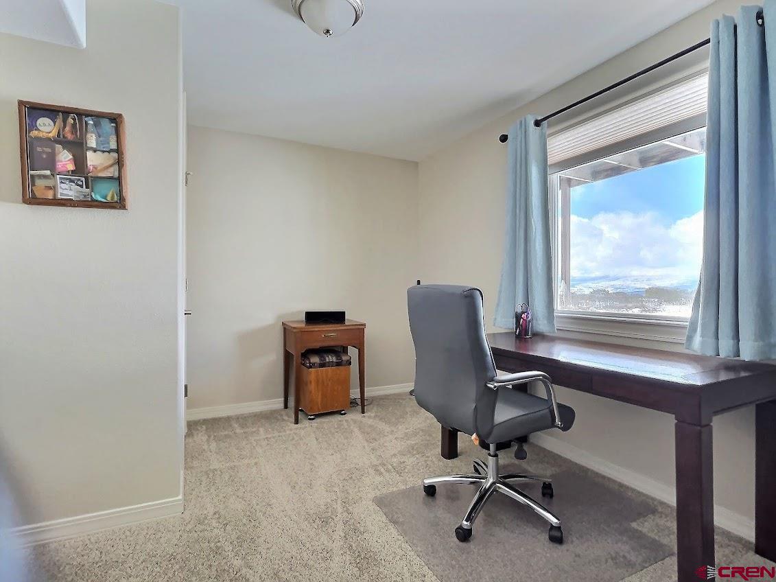 24835 Cactus Park Road Cedaredge, CO 81413 - Photo 19 of 35 a view of a workspace with furniture and a window