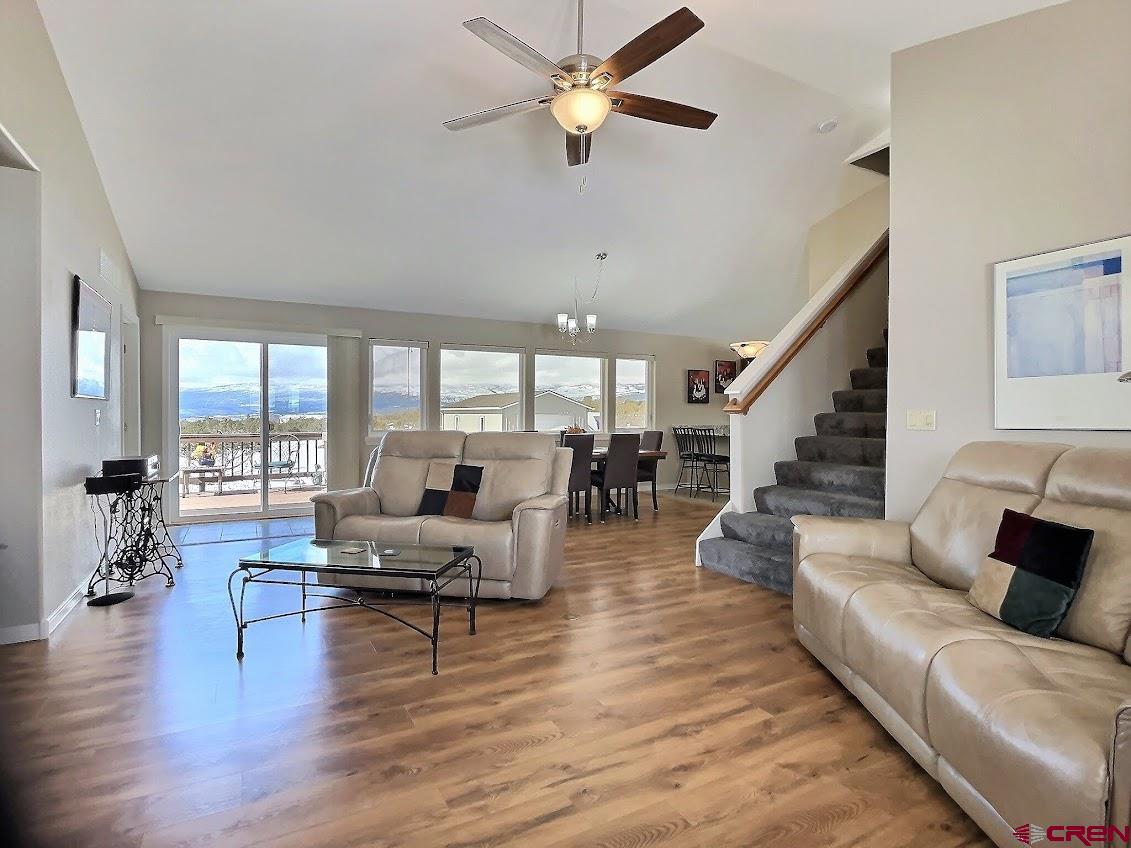 24835 Cactus Park Road Cedaredge, CO 81413 - Photo 2 of 35 a living room with furniture or couches and a large window