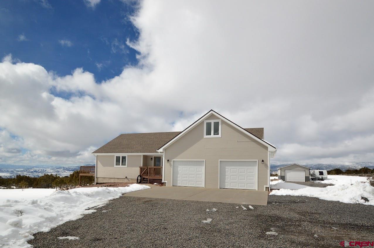 24835 Cactus Park Road Cedaredge, CO 81413 - Photo 25 of 35 a front view of a house with a yard