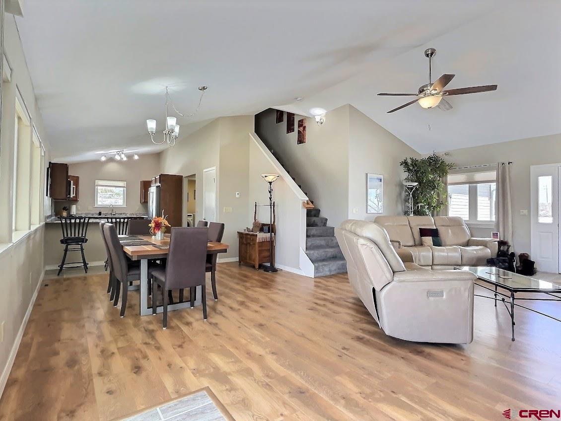 24835 Cactus Park Road Cedaredge, CO 81413 - Photo 3 of 35 a living room with furniture kitchen view and a wooden floor