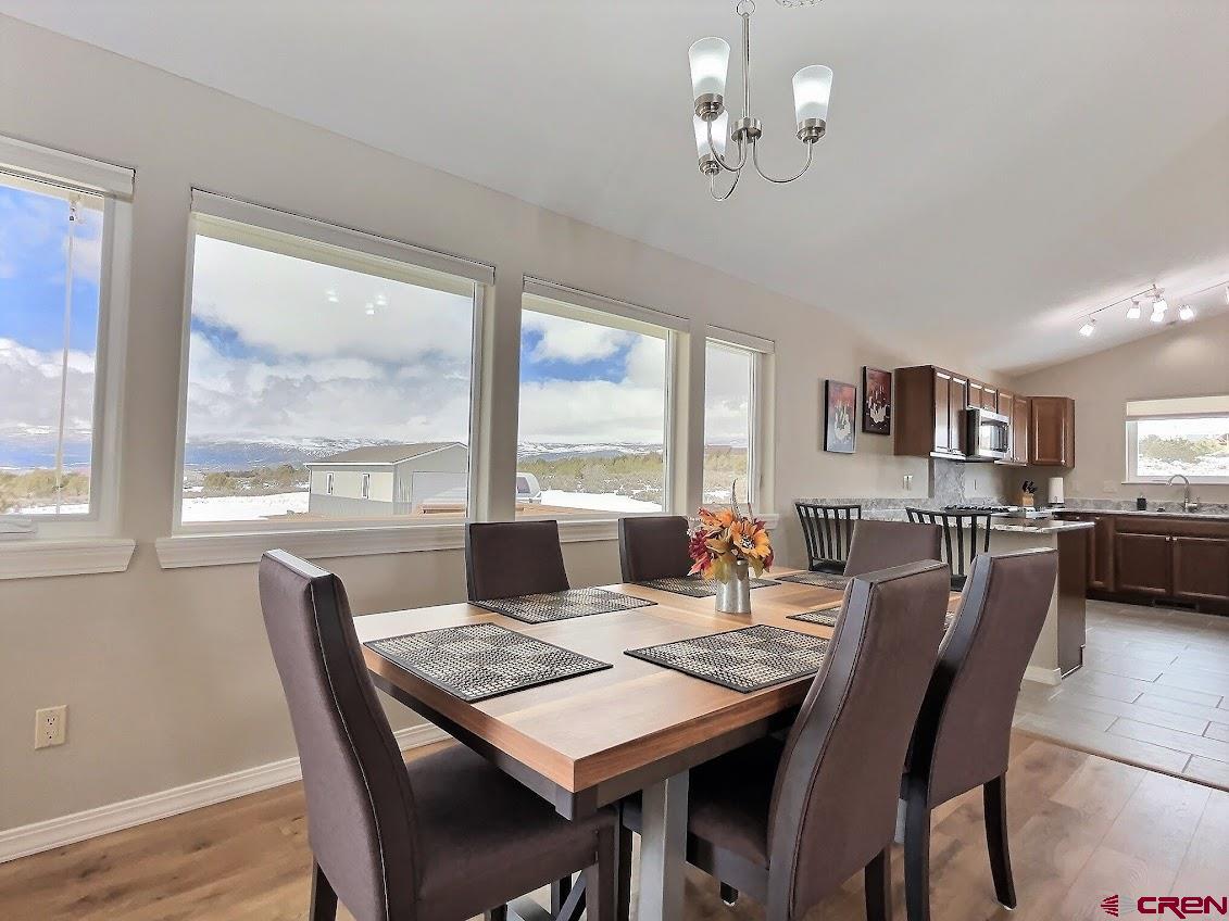 24835 Cactus Park Road Cedaredge, CO 81413 - Photo 5 of 35 a view of a dining room with furniture window and wooden floor