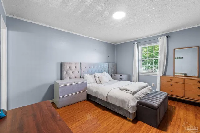 a bedroom with a bed and a dresser