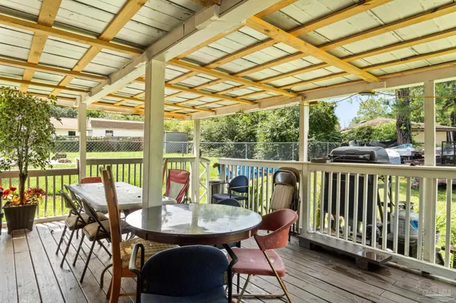 a balcony with furniture and wooden floor