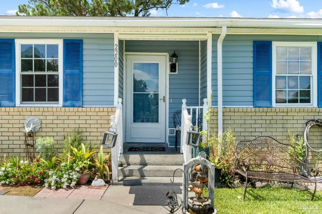 a front view of a house with outdoor seating