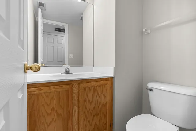 a bathroom with a sink a toilet and mirror