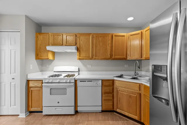 a kitchen with a stove top oven sink and cabinets
