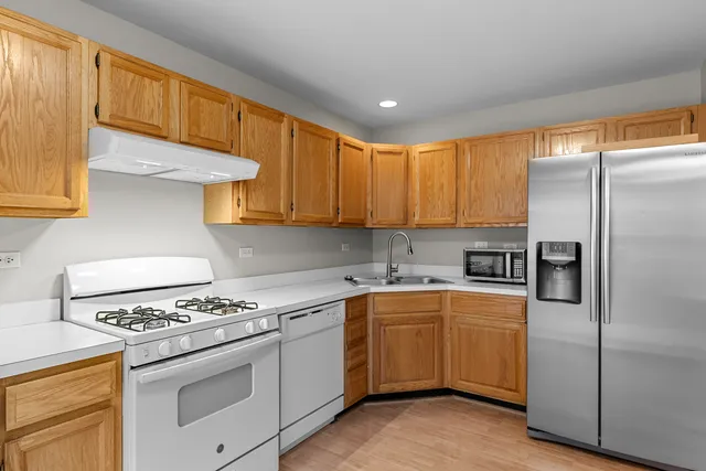 a kitchen with a sink stove and refrigerator