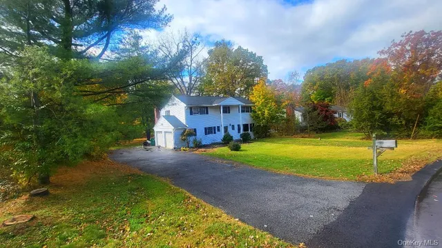 a view of a house with pool and a yard