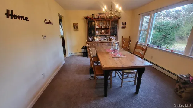 a view of a dining room with furniture and window