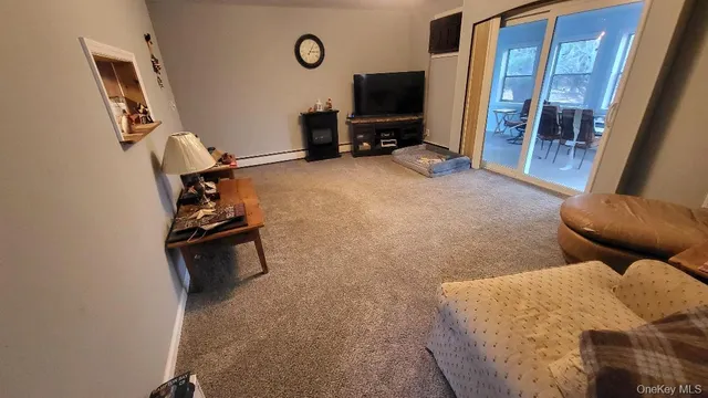 a view of a livingroom with furniture and a flat screen tv