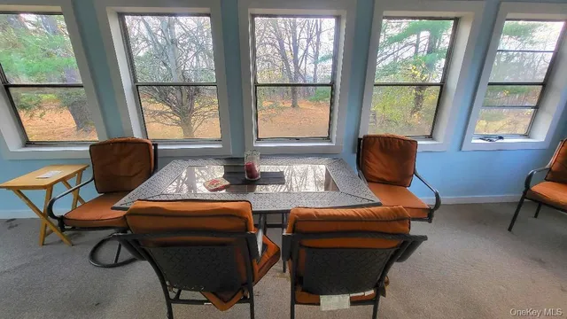 a work room with furniture and a window
