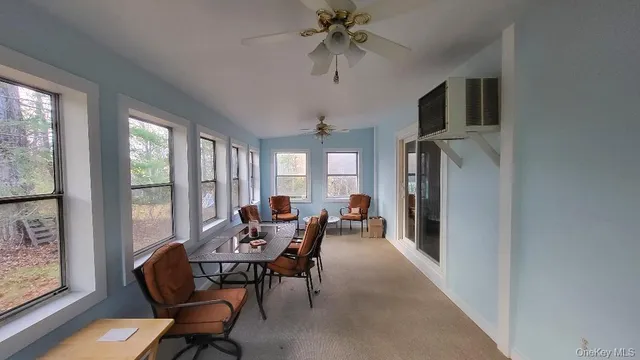 a dining room with furniture a chandelier and window