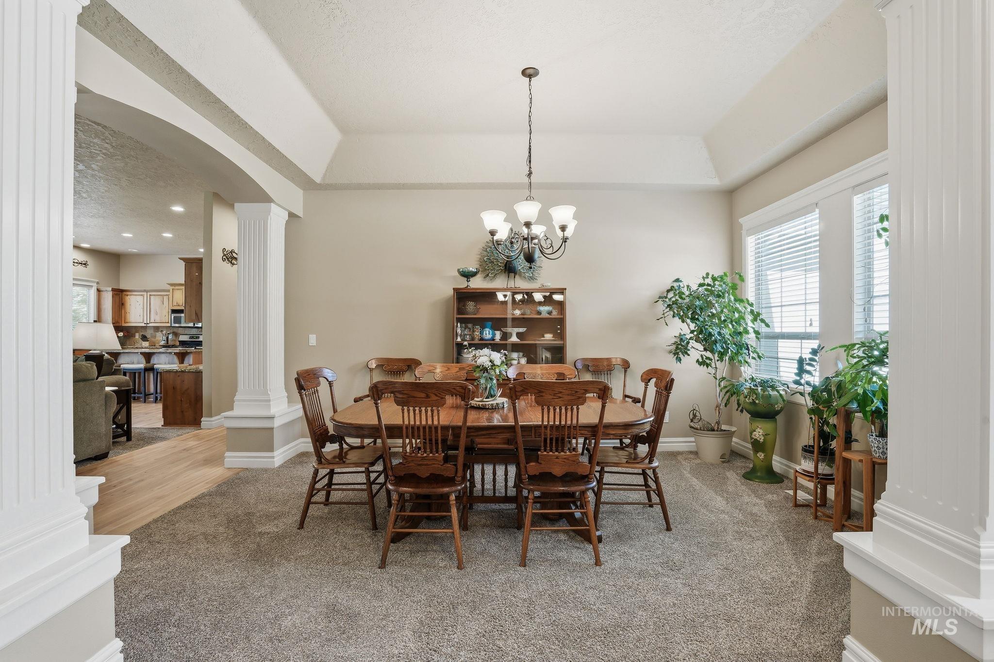 3969 North Hollymount Way Meridian, ID 83646 - Photo 18 of 47 Formal dining area featuring neutral wall tones, recessed ceiling details, and a chandelier with a classic design