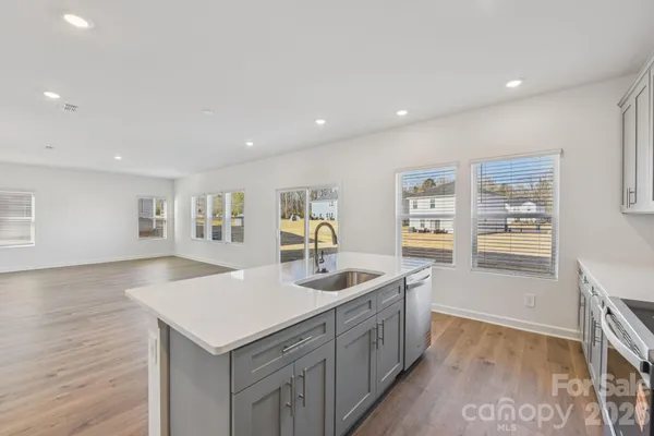 a kitchen with sink and refrigerator