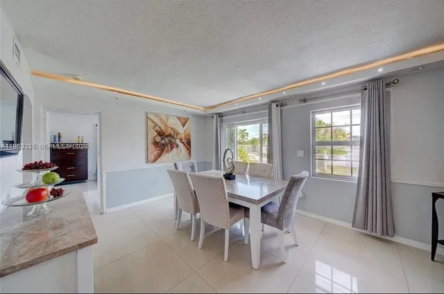 a living room with furniture and painting on the wall