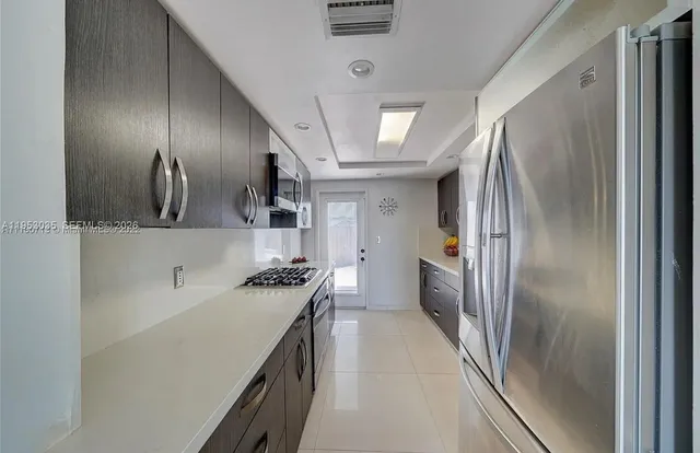 a spacious bathroom with a granite countertop sink a toilet and shower