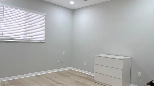 a room with a window and a cabinet