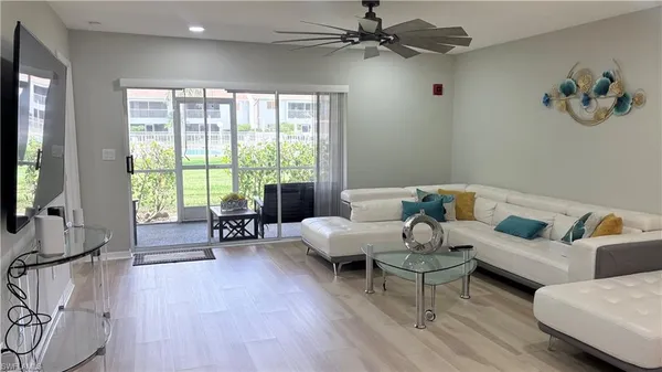 a living room with furniture and a large window