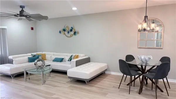 a living room with furniture and a chandelier