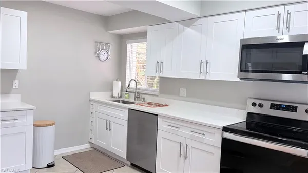 a kitchen with a sink and cabinets