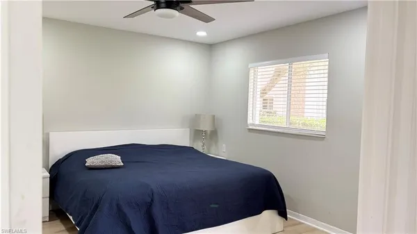 a bedroom with a bed and window