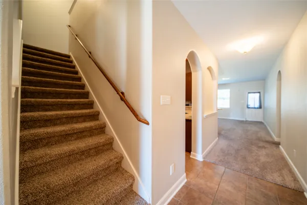 a view of entryway and hall with wooden floor