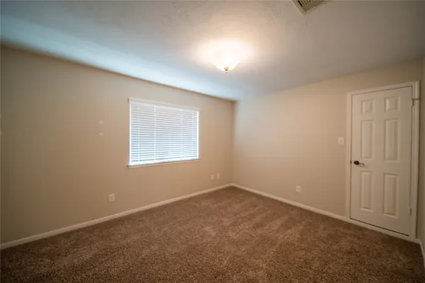 an empty room with a empty space and windows