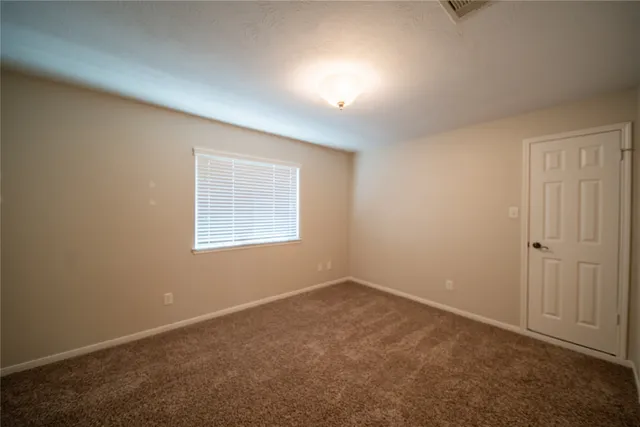 an empty room with a empty space and windows