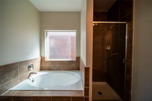 a bathroom with a tub and shower