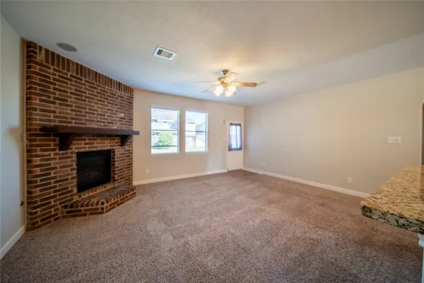 a view of empty room with a fireplace